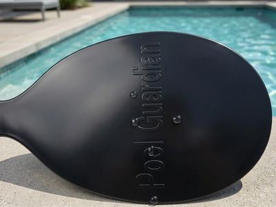 Close-up of the moulded Pool Guardian branding on the sensor mount paddle